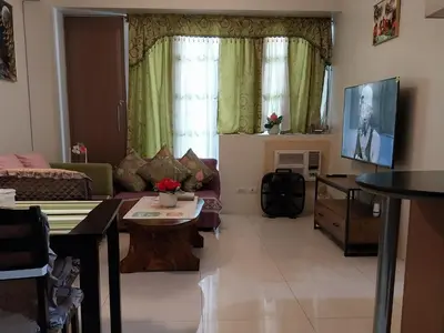 a living room with a couch and a table at KENN PROPERTY in Manila