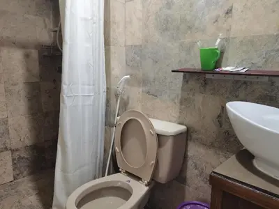 a bathroom with a white toilet and a sink at accommodation service in Manila