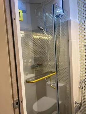 a glass shower door with a toilet in a bathroom at Coast Residence 4026 PENTHOUSE 1 Bedroom Condo with Wifi & Netflix in Manila