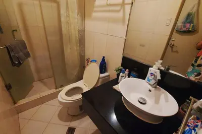 a bathroom with a toilet and a sink and a shower at 1 Br Near Naia T3/Resorts World in Manila