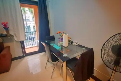 a table and chairs in a room with a window at 1 Br Near Naia T3/Resorts World in Manila