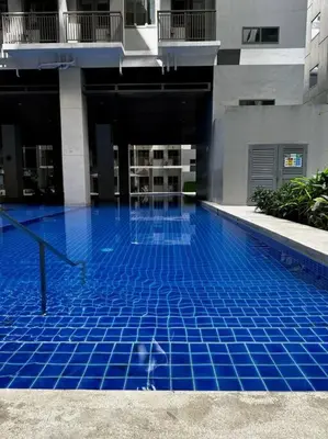 a swimming pool with blue tiles in a building at Hygge Suite @ Moa complex near Naia, Ccp , Dfa in Manila