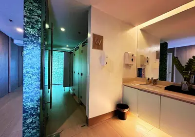 a bathroom with a glass shower and a sink at KL Tower Makati near Greenbelt with free access to gym, sauna & 100Mbps Wi-fi in Manila