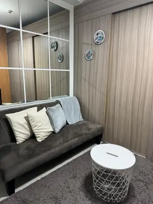 a living room with a couch and a table at Shore 2 Condo unit near MOA in Manila