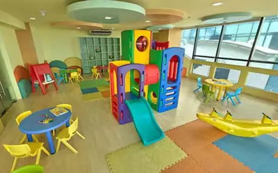 a room with a play area with tables and chairs at Male Bunkbed Room Sharing in Manila