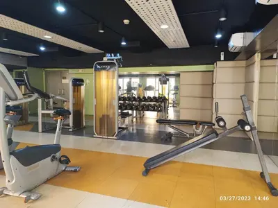 a gym with treadmills and exercise equipment in a building at Larue cozy room in Solemare Parksuites Paranaque in Manila