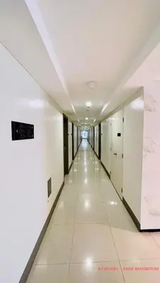 a corridor in a building with white walls and white floors at EJ Homes - Fame Residences in Manila