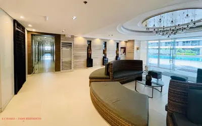 a lobby with couches and chairs and a chandelier at EJ Homes - Fame Residences in Manila