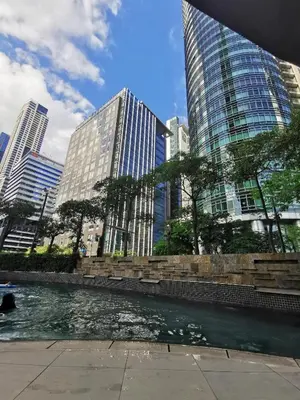 a river in a city with tall buildings at Caleze Properties AVANT at the Fort BGC Studio in Manila