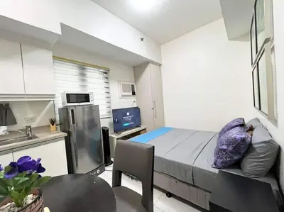 a small room with a bed and a kitchen at KL Tower Makati near AIM, Greenbelt 90mbps WIFI in Manila