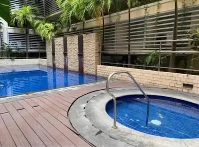 a large swimming pool with a hand rail next to a building at Pasay Staycation with Parking Space in 150 Newport Boulevard near Resort World & NAIA T3 in Manila