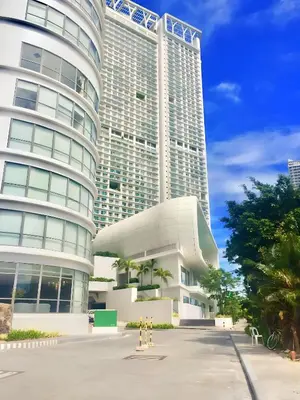 a large building with two tall buildings at Aveline Suites Executive City View ACQUA Private Residences near Rockwell Makati in Manila