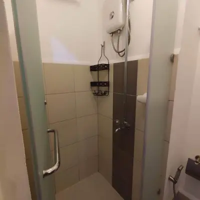 a shower with a glass door in a bathroom at Maicozy condo in Manila