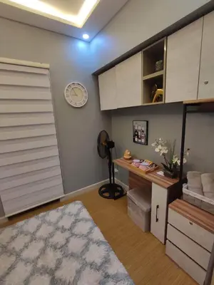 a room with a closet with a desk and a clock at Maicozy condo in Manila