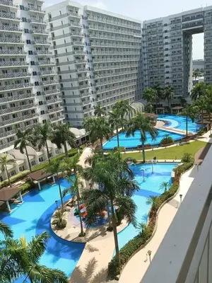 an aerial view of the pools at the resort at Shore 3 Residences MOA Manila in Manila
