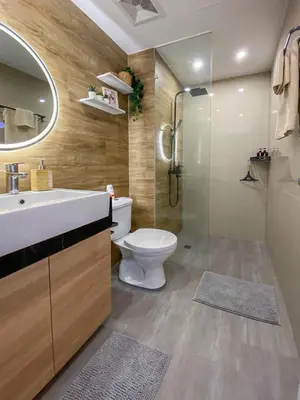 a bathroom with a toilet and a sink and a shower at nJoy! BOHO Luxury at Venice Grand Canal in Manila