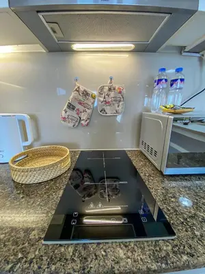 a kitchen with a counter top with a stove at nJoy! BOHO Luxury at Venice Grand Canal in Manila