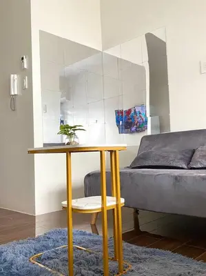 a living room with a table and a bed at Scandinavian Studio in Makati in Manila