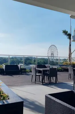 a patio with a table and chairs and a roller coaster at Coast Stay by J 40th floor Penthouse in Manila