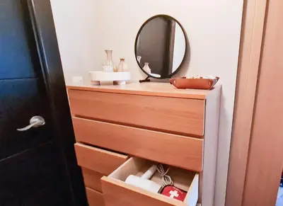 a dresser with a mirror on top of it at Luxe Bonifacio Global City Taguig Uptown Condo Hotel 1 BR Suite in Manila