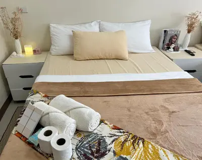 a bedroom with a bed with towels on the floor at Staycation Condotel Room To Stay in Manila