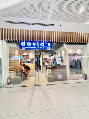 a man sitting in front of a store at 9th Queen Size One Bedroom in Grace Residences, Taguig in Manila